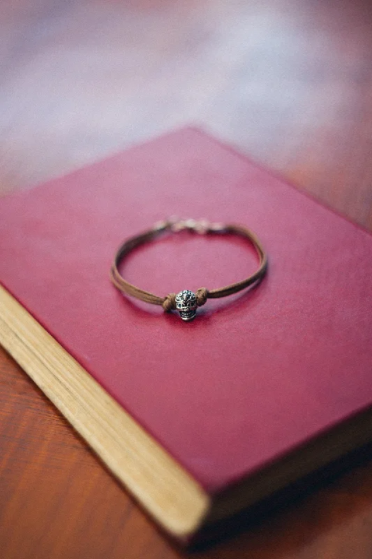 Women’s Bracelet with Birthstones-Men's bracelet with a silver skull bead charm and a brown cords